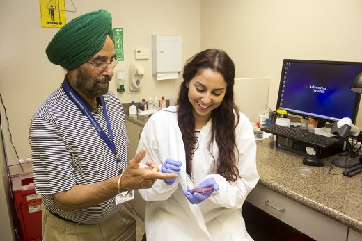Adventist Medical Center opens doors to COS to women interested in science College of Sequoias student Serena Corrales learning from Microbiologist Randhawa at the Adventist Health/Community Care, Hanford lab.